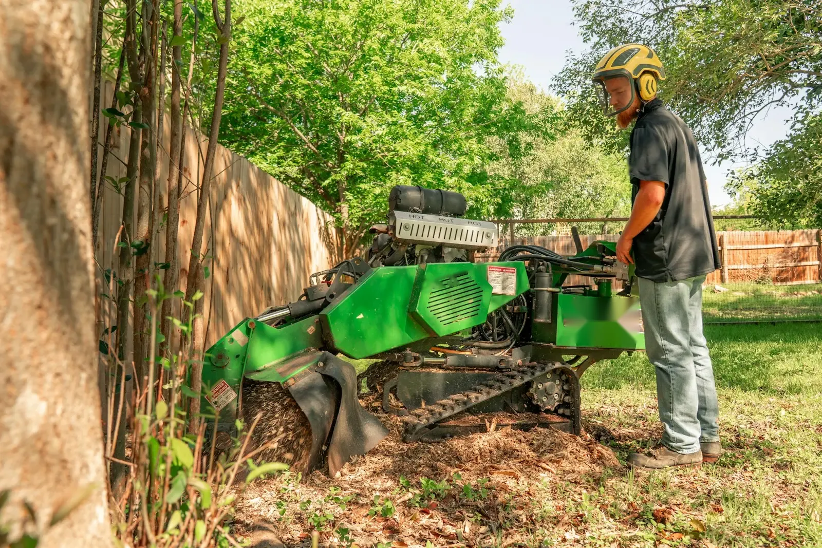 Stump grinder at work in a backyard